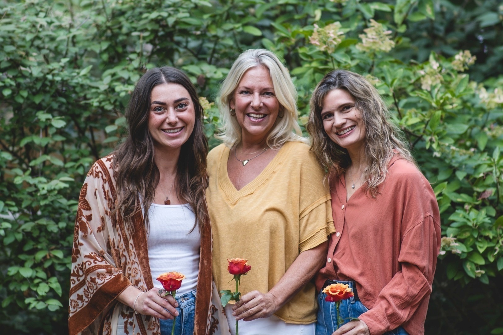 Rachel, Leah and Pneuma in a garden, each holding a rose
